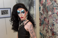 male student dressed as a drag queen at art exhibition