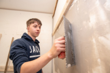 NWRC student plastering wall