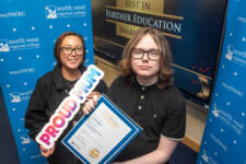 two women hold a certficate and a proud mum sign