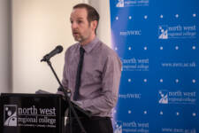 man speaks at a lectern