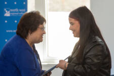 Student receives certificate from a woman shaking his hand