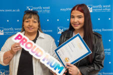 Two women with a sign that says proud mun