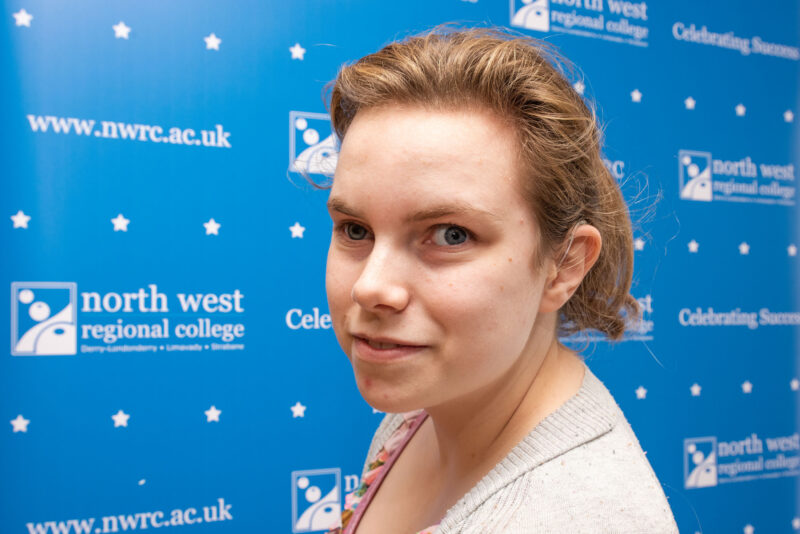 Woman standing in front of NWRC branding