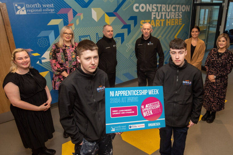 Group pictured holding a sign giving days for Open NI Apprenticeship Week
