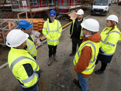 group in high vis and hard hats pictured on a construction site