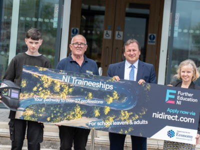 Group of people holding a sign promoting traineeships