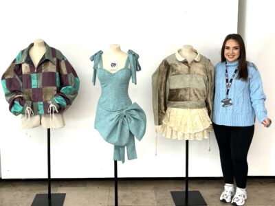 Woman looking at sustainable fashion designs on a mannequin