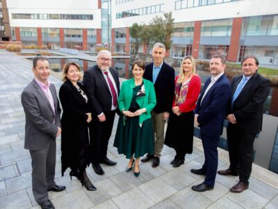 Group of eight people in a line outside a college in Belfast