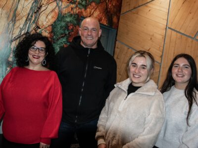 Man and woman pictured with two female students