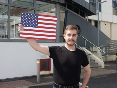 Male student holding an american flag