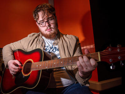 Joe Allan pictured with a guitar in the NWRC Recording Studios2