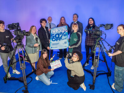 Group pictured in media suite of the college with camera equipment.