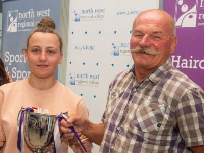 A man and woman holding a trophy