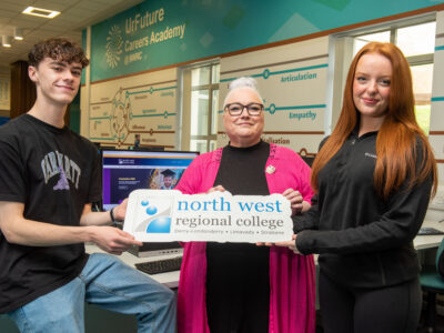 Three people pictured holding on a sign saying North West Regional college