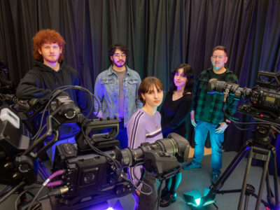 male and female students pictured with television cameras alongside their media lecturer