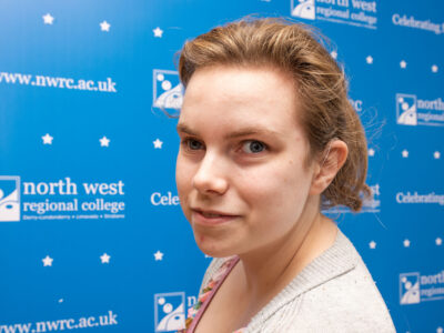 Woman standing in front of NWRC branding