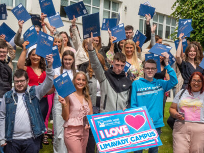 Large crowd outside a college building with a sign that says I Love Limavady campus
