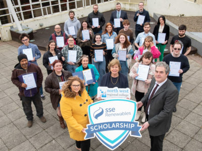 group of students pictured outside the college with SSE renewables shields, and each holding certificates.