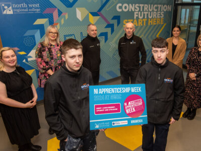 Group pictured holding a sign giving days for Open NI Apprenticeship Week