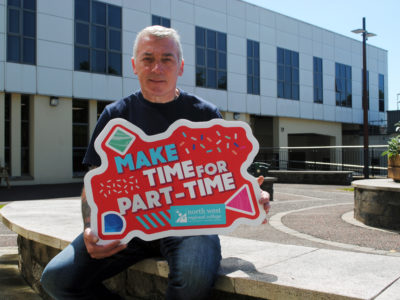 Man holding a sign for part time courses