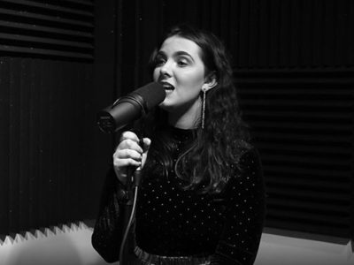 Female music student Juno Hasson, sings into a mic